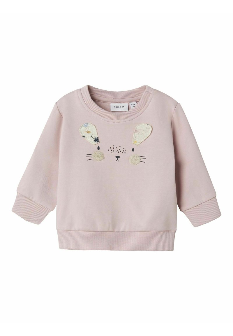 Sudadera rosa con una textura suave, que presenta un diseño de cara de conejo, orejas de felpa y detalles bordados. Puños y dobladillo de canalé.