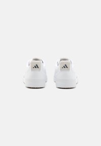 White athletic shoes with smooth leather upper, round toe, and solid rubber sole. Features subtle grey logo accents on heel.