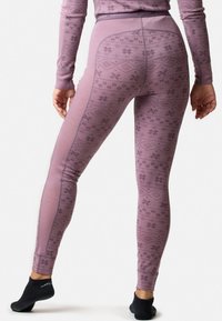 Leggings aderenti in morbido tessuto lavanda testurizzato, con un motivo geometrico a fiocco di neve e una ampia waistband decorativa.