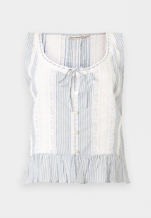 Αμάνικη μπλούζα με μπλε και λευκές ρίγες, διακοσμημένες με δαντέλα, με κουμπιά μπροστά, δέσιμο στον λαιμό και βολάν στο τελείωμα.