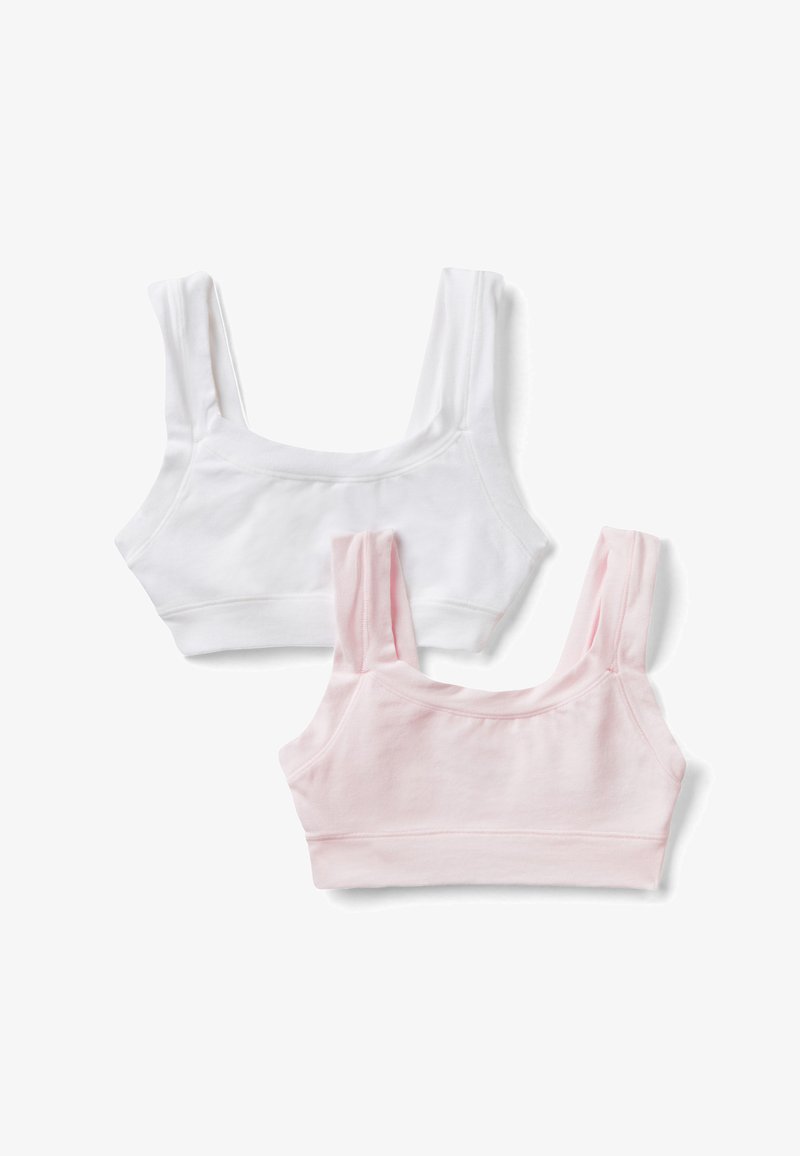 Deux hauts courts sans manches en coton, un blanc et un rose clair, posés à plat sur un fond blanc.