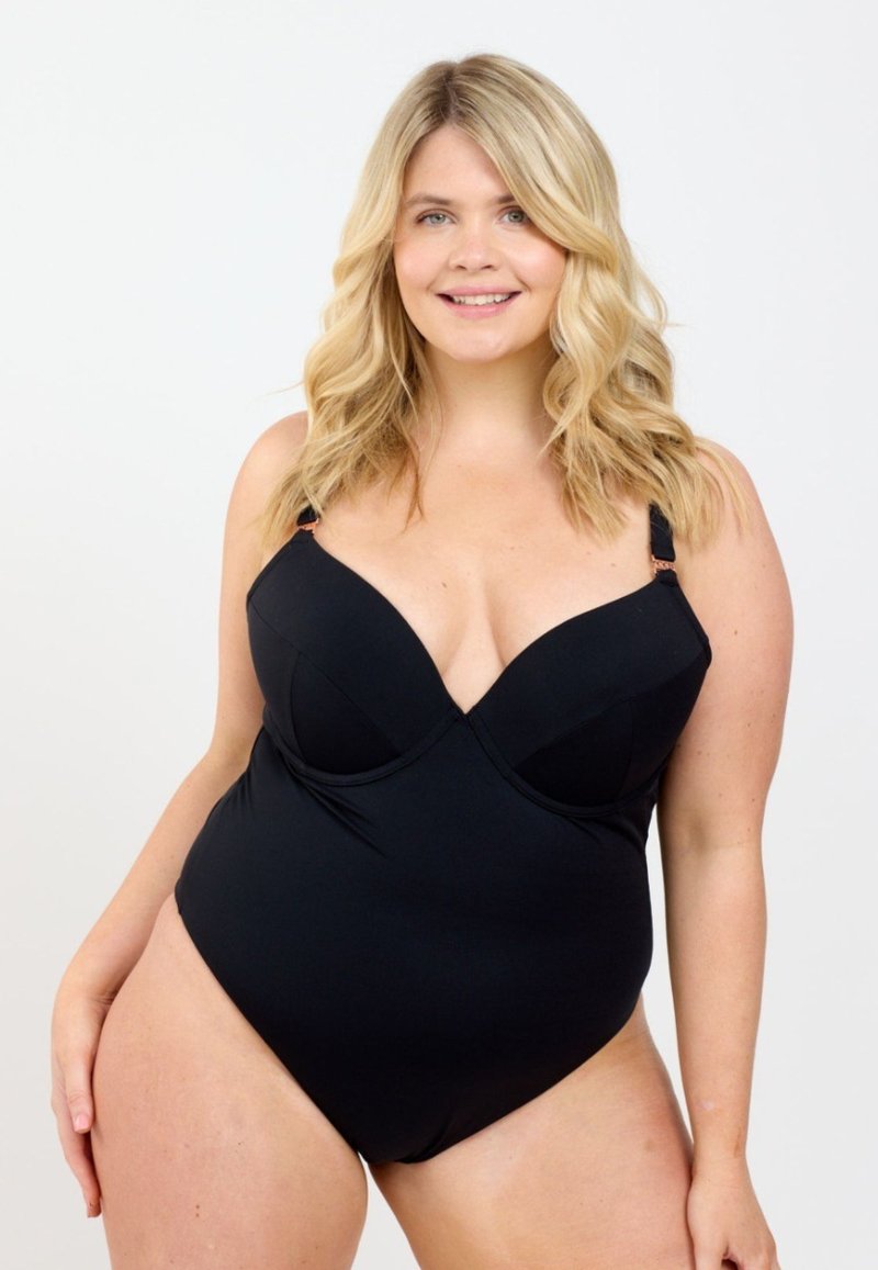 Svart baddräkt med hel kroppen, utrustad med en korsad framsida, formade kupor, justerbara axelremmar och en slät textur. Enkel och figursydd silhuett.