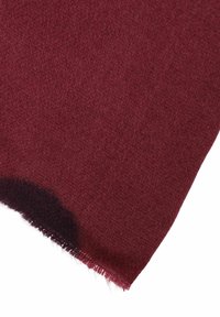 Burgundy wool fabric with a textured weave, featuring a frayed edge and a darkened area near the corner.