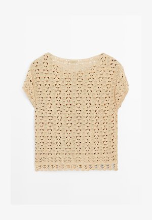 Beżowy krótkosleeve'owy top z dzianiny szydełkowej z kwiatowym wzorem z dziurkami i falbaniastym wykończeniem, ułożony na białym tle.
