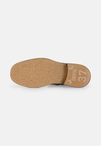 Semelle de chaussure en texture de liège avec une forme arrondie, couleur beige, et le numéro 37 imprimé sur une section plate en cuir lisse.
