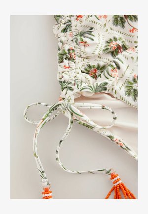 Blommig baddräktstopp med vit bas och gröna palm- och blommönster. Avslutat med justerbara snören och orangea pärldekorationer.