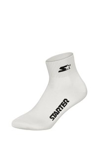 Weiße Knöchelsocke aus strukturiertem Stoff, mit einem schwarzen Logo und Branding an der Seite. Gerippter Bund für einen sicheren Sitz.