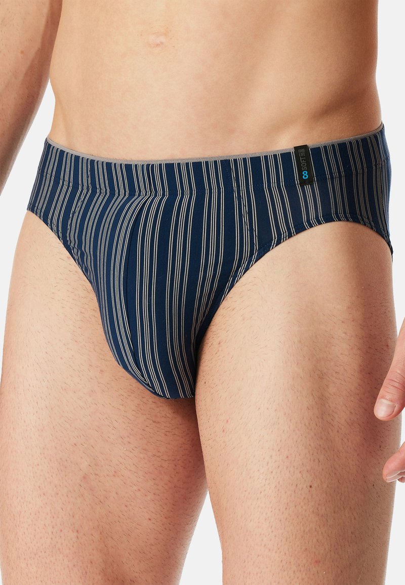 Marineblaue Unterhose mit vertikalen weißen Streifen, elastischem Bund und weichem Stoffgefühl. Verfügt über ein Etikett auf der linken Seite.