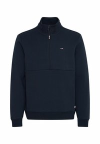 Sudadera azul marino de media cremallera fabricada en un tejido suave, con un cuello alto y un pequeño logo en el pecho. Puños y dobladillo acanalados.