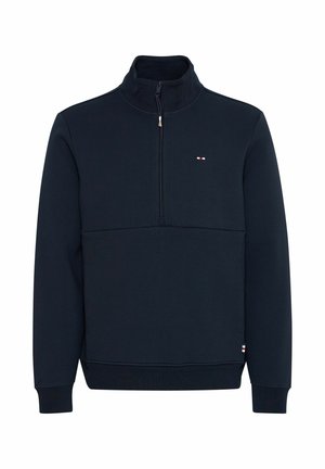 Sudadera azul marino de media cremallera fabricada en un tejido suave, con un cuello alto y un pequeño logo en el pecho. Puños y dobladillo acanalados.