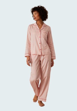 Striped pink pajamas made of soft fabric, featuring long sleeves, a button-up shirt with a pocket, and loose-fitting pants.