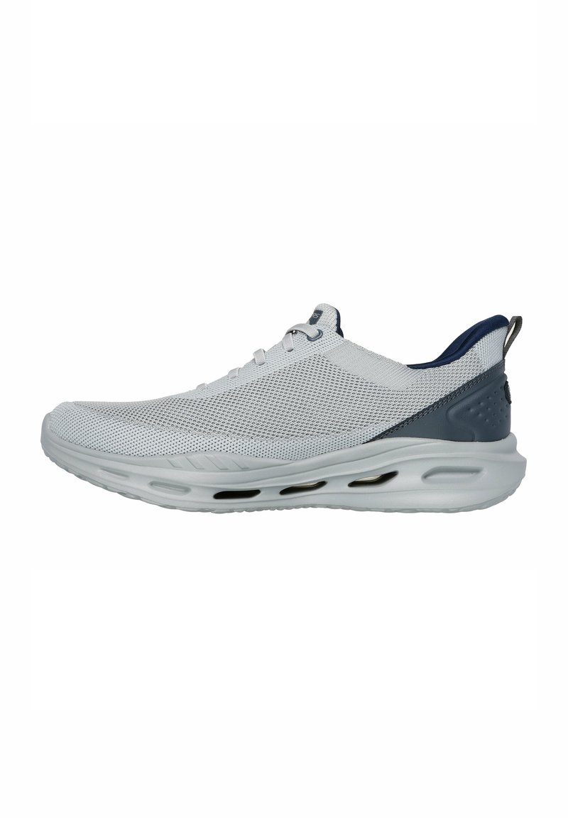 Mesh athletic shoe in white with navy accents, featuring a lightweight design and air cushioning, smooth texture, and rounded toe.
