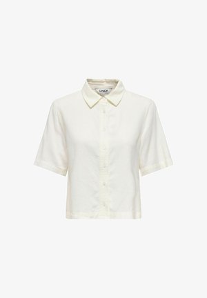 Kermanvärinen lyhythihainen nappipaita, jossa on terävä kaulus, lyhyt helma ja brändilogo kauluksen sisäpuolella.