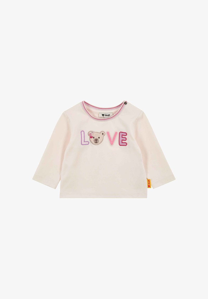 Camiseta de manga larga para niño pequeño de color crema con la palabra "LOVE" bordada, donde la "O" es reemplazada por la cara de un oso, y detalle en el ribete del cuello con rayas rosas.