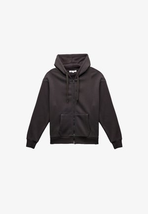 Tummanharmaa vetoketjuhuppari, jossa on etutasku, nyörit ja pehmeä sisävuori; varustettu ribbineulevaroilla ja -helmalla.