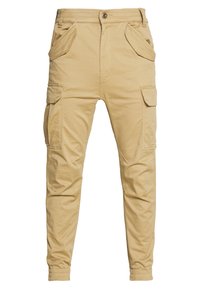 Beige cargobyxor i bomull, med flera sidofickor, knappstängning, avsmalnande ben och elastiska muddar.