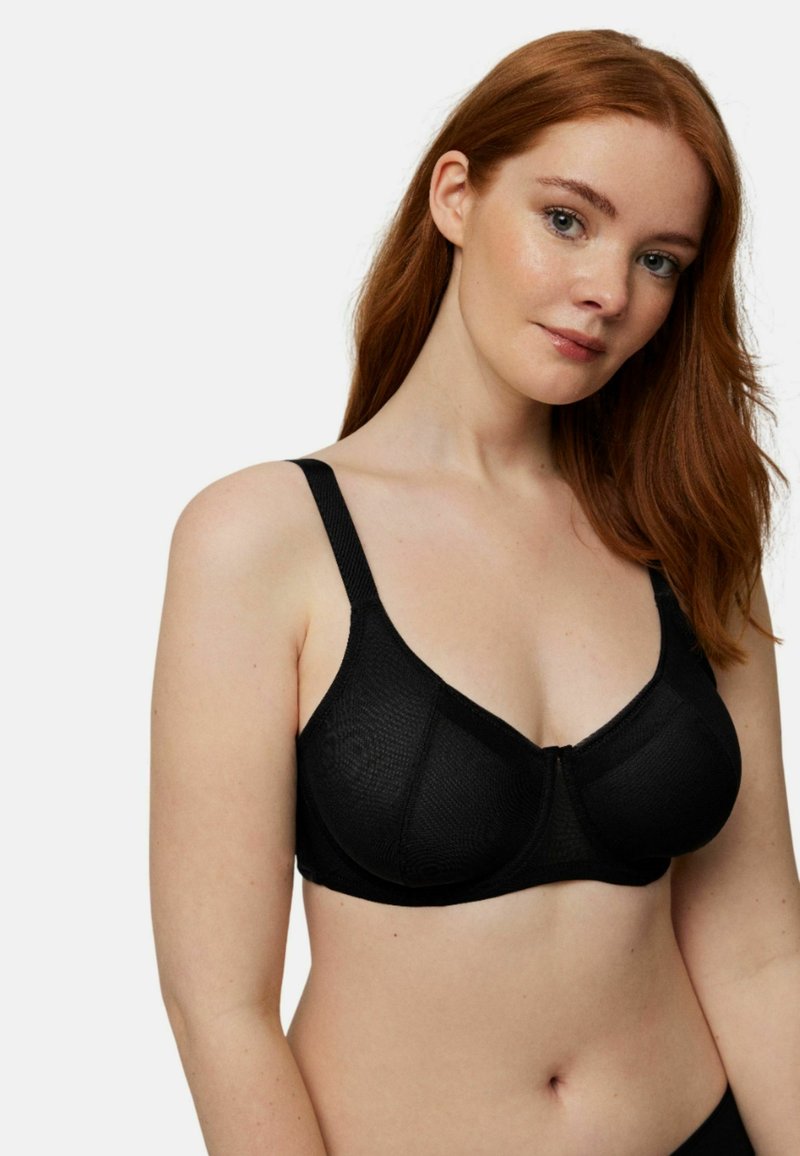 Sujetador negro con aro, tela texturizada, tirantes ajustables y diseño sin costuras que muestra una estética simple y minimalista.