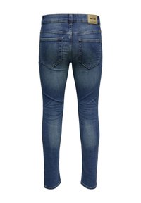 Skinny blue denim jeans feature a mid-rise waist, two back pockets, and a faded wash with subtle whiskering near the thighs.