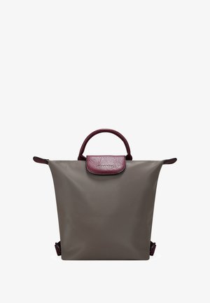 Mochila impermeable gris con una solapa texturizada en color marrón burdeos, doble asa superior y correas ajustables. Diseño minimalista sin herrajes visibles.