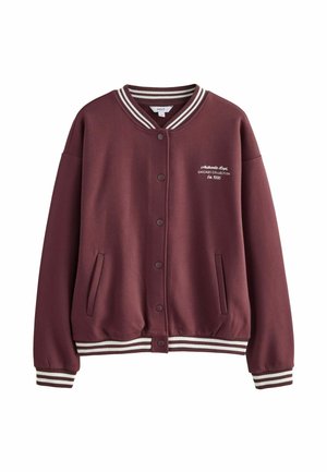 Maroon varsity jacket with ribbed cuffs and hem, white stripes, two side pockets, and embroidered text on the chest. Smooth fabric texture.