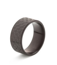 Black ring made of a smooth material featuring a textured surface with a geometric triangular pattern. Round shape, consistent width.