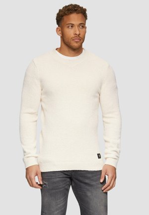 Witte gebreide trui met een V-hals, gestructureerde stof, lange mouwen en een ribbelzoom. Heeft een klein zwart merketiket aan de zijkant.