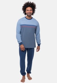 Blue and navy striped long-sleeve shirt with ribbed cuffs paired with blue pants, all made from soft, lightweight fabric.