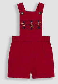 Punast corduroy-tudengite üleriided elastse vöökoha, nupuvööde ja tikitud marssimisorkestri muusikutega rinnaosas.