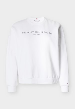White sweatshirt made of cotton blend; features ribbed cuffs and hem. Front displays “TOMMY HILFIGER EST. 1985” logo in black.