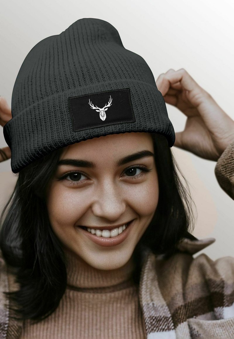 Knitted black beanie with a textured pattern and a rectangular patch featuring a white deer head graphic.