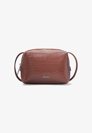 Sac bandoulière en cuir marron à texture crocodile avec fermeture éclair argentée et petit logo Calvin Klein à l'avant.