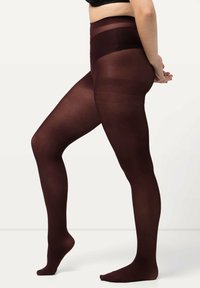 Burgunderfarbene blickdichte Strumpfhosen mit glatter Textur, hohem Bund und ohne Füße, gezeigt an einem Modell im Profil.
