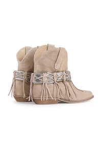 Beige suede ankle boots with a rounded toe, silver accents, and leather fringe detailing around the ankle, set on a stacked heel.