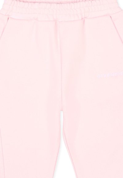 Pantalon de jogging rose clair avec taille élastique et poches latérales, avec petit logo blanc Givenchy sur la cuisse droite.