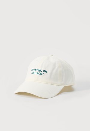 White baseball cap with dark green embroidery reading "NO CRYING ON THE YACHT" on front, shown against a plain light background.