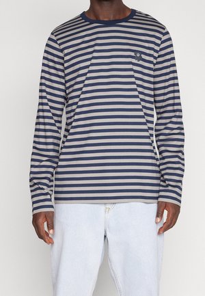 Long-sleeve striped t-shirt in navy and beige, featuring a round neckline and a small logo detail on the chest. Soft cotton blend material.