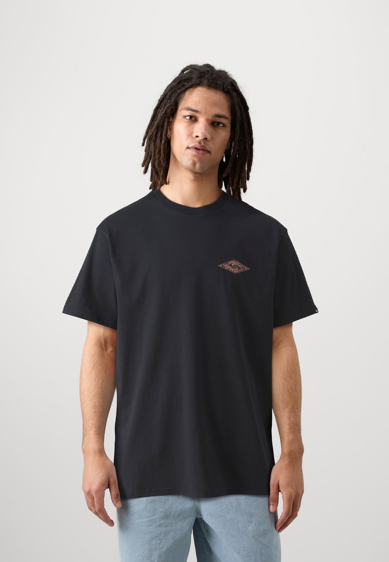 Black cotton t-shirt with a loose fit, round neck, and a small, diamond-shaped graphic in orange and brown on the left chest area.