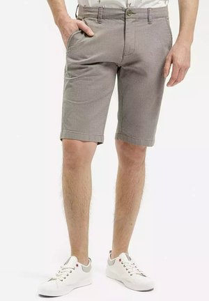 Gray shorts made of textured fabric, featuring a button closure, side pockets, and rolled cuffs. Paired with white sneakers.