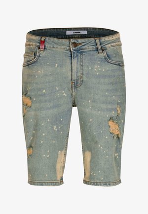 Jeansshorts i en falmet blå farve med slidte områder og hvide sprøjtede mønstre. Standard forlommer og lynlåsdesign.