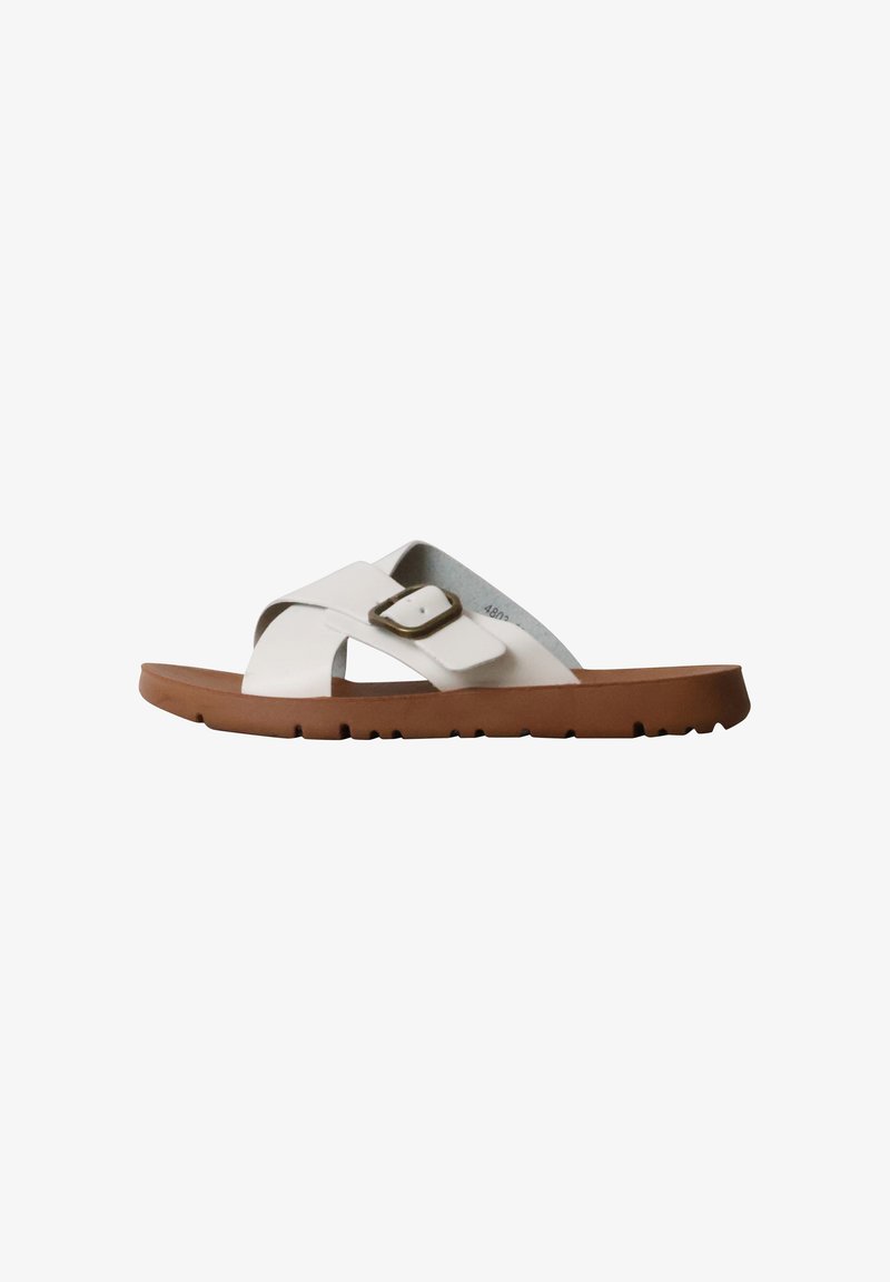 Sandale blanche à enfiler avec des brides croisées, une boucle bronze réglable et une semelle épaisse marron, montrée en profil latéral sur fond blanc.