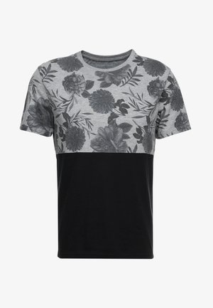T-shirt à manches courtes avec un motif floral gris sur la moitié supérieure et un bas uni noir ; en coton, col rond.