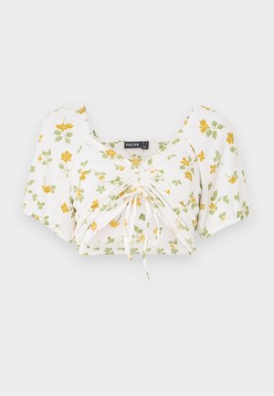 White crop top with short puff sleeves, featuring yellow and green floral print. Ruched center with adjustable drawstrings for fit.