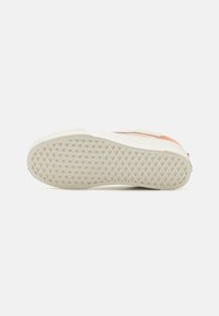 White sole with textured pattern and light beige edge; features a pinkish-red accent near the heel and a contrasting black stripe.