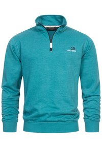 Suéter de manga larga en color teal con cremallera de cuarto, puños y dobladillo acanalados, y un pequeño logo con "Est. 1993" en el pecho.