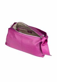 Purple leather handbag with wide strap, unzipped to show beige interior lining with small dark heart patterns and inner zip pocket.