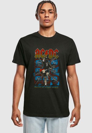 Black short-sleeve t-shirt featuring an AC/DC graphic with a guitarist, multicolored elements, and the text "BLOW UP YOUR VIDEO."