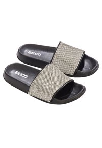 Sandales à glissière noires avec une bride en strass argentée scintillante, semelles plates et un intérieur de pied texturé noir. Marque visible sur le côté.