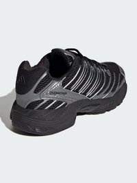 Čierna športová obuv s hornou časťou zo sieťoviny so striebornými akcentmi, pevnou gumovou podrážkou a elegantným dizajnom pre lepšiu podporu.