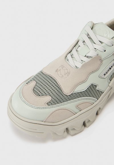 Light green sneakers with beige accents, featuring mesh and suede detailing, thick rubber sole, and logo on the side.