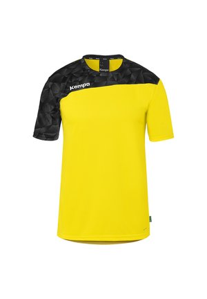 Maillot de sport jaune à manches courtes avec un motif géométrique noir sur le haut de la poitrine et l'épaule gauche, arborant le logo blanc "Kempa" sur la poitrine.